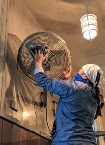 Next, Dolma wipes down every fan with a damp towel. I always remind my crew that taking good care of our equipment will help them run more efficiently and last longer.