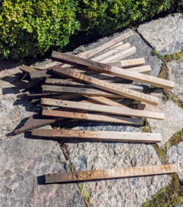The crew also removes the wooden stakes that hold up the framing. These stakes, which are an inch-and-a-half by an inch-and-a-half, were milled right here at the farm. These wooden stakes are also gathered and stored for later use. It is important to me that nothing is wasted.