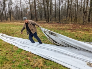 And, at one end of the composting area, Phurba pulls a Gore-Tex tarp off one of the compost piles now ready to use in the gardens. These tarps keep the rain away, and allow excess moisture to evaporate and breathe.