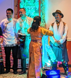 Pasang, Domi, and Chhiring receive Buddist scarves on stage.