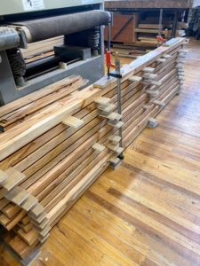 Here are the cut pieces spaced with smaller wood shims to allow air to circulate between the pieces and allow the wood to acclimate after milling.