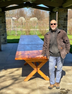 Here's Peter in front of the long table after all the tops were well secured to the legs and trestles. Each table weighs about 300-pounds - wind will not bring it down.