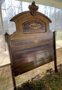 A stunning antique head board. This one goes with an entire bedroom set... all for sale!