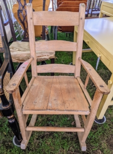 A rocking chair, ready for a fresh coat of paint... for sale!