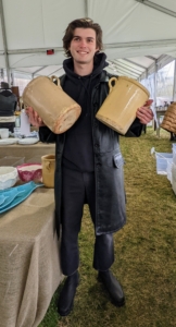 As tables emptied, our team put out more merchandise. Here's James LaBorne taking out more pottery to fill the tables.