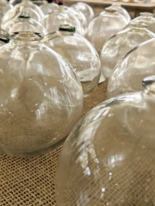 Do you know what these are? They are glass floats. Also known as glass fishing floats, or Japanese glass fishing floats, these are now popular collectors' items. They were once used by fishermen in many parts of the world to keep their fishing nets and longlines afloat.