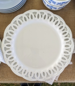 I have so many tables filled with dishes, bowls, and other ceramics. There are so many different colors and styles - you'll want them all. These white plates... for sale!