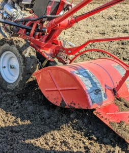 The machine is set to till the soil at about six to eight inches deep. On some tillers, the speed of the rotating tines helps determine the speed of the machine.