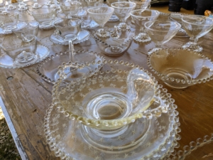 There is a lot of glassware for sale at Brimfield, such as these hobnail glass bowls, goblets, and teacups.