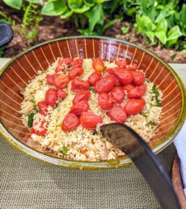 This is couscous with herbs and cherry tomatoes - a perfect accompaniment to our barbecued chicken and beef kebabs.