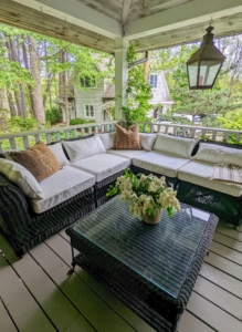 On the expansive wrap around porch is a very inviting space with a large, comfortable sectional for cool summer evening chats.