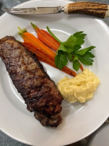 Here's my plate. Our grilled steaks were served with carrots from Triple Chick Farm and a helping of polenta - a northern Italian dish made of coarsely ground corn. Freshly cooked, polenta is soft and creamy, like porridge.
