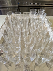 Glasses are washed, wiped dry, and also placed on a tray - any chores that can be completed ahead of time are done the day before, so there is as little rushing around as possible the day of the event.