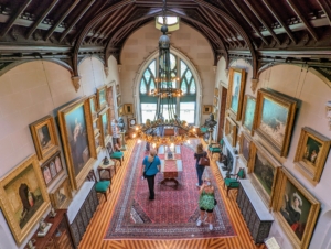 The main house has a soaring two-floor Art Gallery, which was once also used as a library and billiards room. Today, the room is filled with 19th century academic paintings along with Tiffany glass windows and other period furnishings designed by Davis.