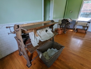 There were also two large mangles, or wringers - mechanical laundry aids consisting of two rollers in a sturdy frame, connected by cogs and powered by a hand crank or by electricity. I love mangles and have them in every home for ironing sheets and other linens.