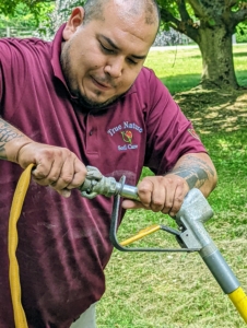 Rocky's son, Eric, puts together the AirSpade - a hose attachment for a compressor that can shoot air and uncover sensitive tree roots without harming them.