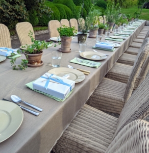 For the centerpieces, we placed potted herbs down the entire length of the table. I bought the chairs years ago during my catering days - 450 wicker chairs and they still come in so handy for these large parties. Each longtime employee had a small gift from me at their place setting.