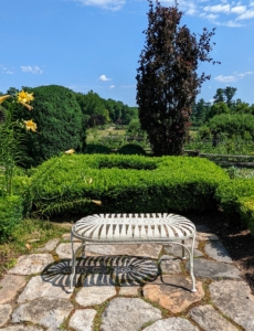 One single bench is placed in front of the herb garden with a perfect view of the paddocks and stable beyond. We are in desperate need of some rain here in the Northeast and in much of the country, but the gardens are looking beautiful this season.