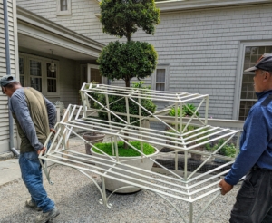 In the courtyard behind my Winter House kitchen, Pete and Dawa transport this large plant stand.