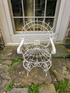 Over in front of this window is a dainty single chair - also in the same Victorian era style. But look closely...