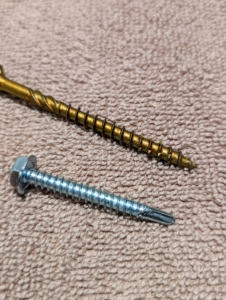 Here is the self-drilling screw next to a wood screw. One can see how the base of the screw has the drill bit shaped point.