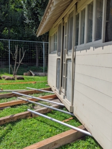Earlier this month, I showed you how we moved the peafowl coop a short distance using an old fashion method of rolling the structure over aluminum poles into its desired place. Here is the coop just before it was moved.