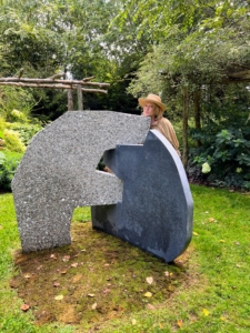 This art sculpture is by artist Sam Moyer called Bluestone Dependent 4, 2021. It is made from Belgian bluestone and concrete with stone aggregate.