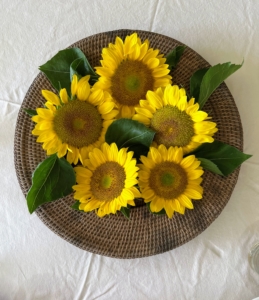On our table - a charming arrangement of cut sunflower blooms.