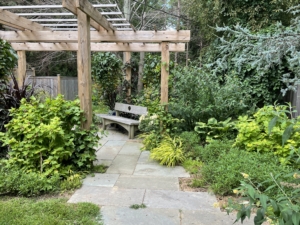 Dennis designed the Moongate Bench under this pergola. It’s part of his signature furniture line that he sells at Landcraft Environments. (Photo courtesy of Landcraft Environments Ltd.)