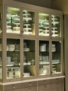 Another restaurant cabinet shows the many cake stands and dishes inspired by my own personal everyday collections.