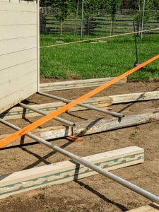 Giant straps and rope are used to secure the coop to the Hi-Lo.