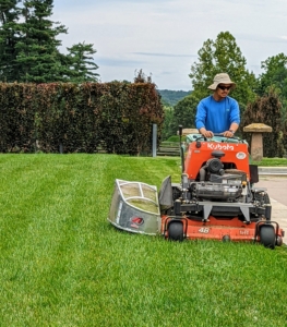 Here is my outdoor grounds crew foreman, Chhiring, mowing the lawn around the pool. He is on our Kubota SZ22NC-48 stand-on mower. We use this to mow areas where the riding mower cannot go.