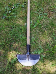 This is a razor-back half moon edger. It's designed to cut back grass or move rocky soil that ends up over the edges of flower beds and sidewalks. The top edge also has a turned step for secure foot placement.
