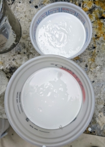 The next step is to prepare the glue or Polyaspartic - a tinted primer base coat that will allow the flakes to adhere to the surface.