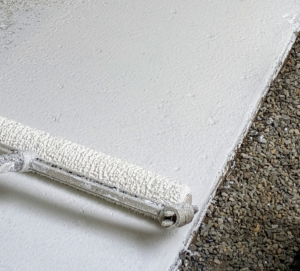 Omar uses a floor painting roller to apply this base coat. This will ensure maximum adhesion to the prepared substrate. Priming also helps to seal any air in the concrete that could cause bubbling on the finished surface.