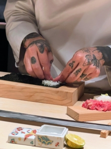 Here, Chef Wayne starts building a Negitoro Roll. It consists of cooked rice with minced tuna and green onion. Chef Wayne places the rice on the nori, or seaweed paper.