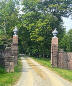 This is the historic front gate at Wethersfield Estate & Garden. The leaded urns are topped with camels from the Stillman Family crest.