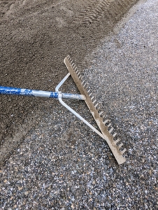 This razor-back aluminum landscape rake has a wide head and teeth to level gravel quickly and smoothly. These landscape rakes are easy to find at home improvement shops and some gardening centers.