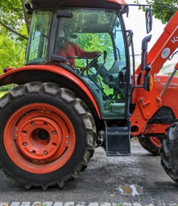 As the tractor and power rake drive over them – very slowly – about three miles per hour, it moves the gravel and dust to level the area and get rid of the depressions.