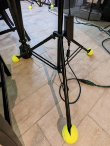 In the entertainment business, one will see various pieces of equipment with tennis balls on the feet of lights and microphone stands. They're used to protect the floors - just cut slits in them and place them on to cushion and pad the feet.