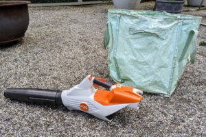 Once all the work is done, Phurba uses our STIHL battery-powered blower to clean up all the cuttings. We use this blower every day to clean up any debris around my Winter House. On the right is one of my Multi-Purpose Reusable Heavy Duty Tote Bags. These bags take a beating around the gardens, but they're so strong and so useful.