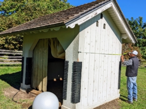This is the run-in. My donkeys love this structure and use it frequently to get out of the hot sun or in winter when it is very stormy. Here, Pete Sherpa from my outdoor grounds crew, measures the shed's length and width.