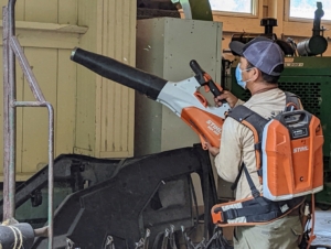 Chhiring is using our STIHL battery-operated blower to get any dust or debris off the walls.