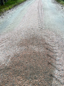 Here you can see the gravel pile begin to narrow. Underneath the crushed pink granite is pure carriage road – built using layers of crushed rock, and several inches of crown for proper drainage that are perfect for horse-drawn carriage rides, bicycling, and walking.
