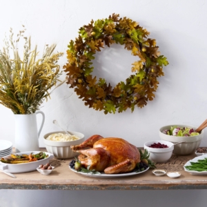 Don't forget the holiday runner and wreath. My Faux Oak Leaf 16-inch Wreath features pale green leaves with gold and brown tones - it looks like it was just made from the fall foliage. The elegant, natural colored runner shows decorative script and beautiful illustrations for the table - both are available on Martha.com.