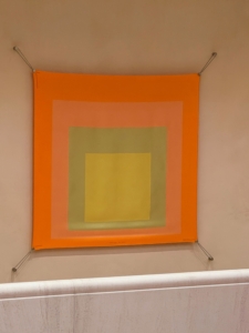 On this wall, there was a scarf designed after artist Josef Albers' "Interaction of Color: Homage to the Square" painting.