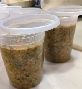 I freeze my containers until they are ready to use. If planning to freeze, only fill up to the first line around the container so it has room to expand. Here, the quarts of food are left to cool a bit before securing the lids.
