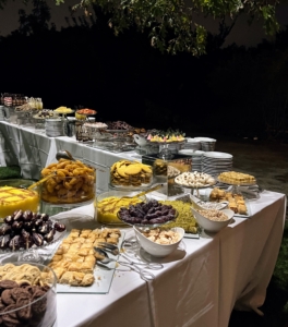 A lavish dessert buffet includes a selection of summer fruits, my own lemon meringue tartlets, assorted mousse shots, homemade chocolate barks, chocolate dipped fruits, chocolate clusters and truffles, Persian sweets baklavah, bamieh, sholezard, and graybeh, stuffed dates, marzipan fruits, knafe, koluchen yazdi, chay and rock candy, and a Persian tea station.