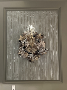And here is a wreath hung around a sconce - also something I like to do in my own home.