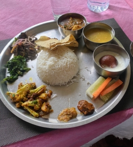 One of the first things Dolma did was eat some of her favorite foods. This is a plate of traditional Nepali foods. It is called Thakali and often includes rice, vegetables, buckwheat finger chips, and served with pickles and curry sauce.